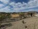 View of a fenced in dog park featuring desert landscaping and shade structure at 1503 S 239Th Dr, Buckeye, AZ 85326