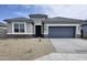 Charming single-story home featuring stone accents, a gray exterior, and a low-maintenance gravel yard at 1503 S 239Th Dr, Buckeye, AZ 85326