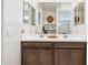 Bright and airy bathroom with double sink vanity, light cabinets, and decorative accents at 1531 S 239Th Dr, Buckeye, AZ 85326