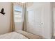 Bedroom featuring sliding closet doors, pendant light, and window with bright natural light at 1531 S 239Th Dr, Buckeye, AZ 85326