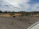 View of the community park with a fenced perimeter, dry desert landscape, and view of local homes at 1531 S 239Th Dr, Buckeye, AZ 85326