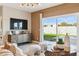 Cozy living room with a modern entertainment center, plush seating, and sliding glass doors to the backyard at 1531 S 239Th Dr, Buckeye, AZ 85326