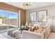 Bright living room with neutral tones, modern chandelier, and sliding glass doors to the outdoor space at 1531 S 239Th Dr, Buckeye, AZ 85326