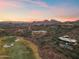 Beautiful sunset aerial view showcasing luxury homes, golf course, and mountain views at 15504 E Firerock Country Club Dr, Fountain Hills, AZ 85268