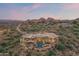 Expansive aerial view of a luxury estate nestled in the desert mountains, featuring a pool, and stunning architectural design at 15504 E Firerock Country Club Dr, Fountain Hills, AZ 85268