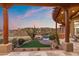 Inviting backyard with pool, lush grass, and outdoor dining area, framed by desert landscape views at 15504 E Firerock Country Club Dr, Fountain Hills, AZ 85268