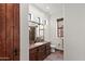 Bathroom features a dark wood cabinet, a sink, a toilet, and a mirror at 15504 E Firerock Country Club Dr, Fountain Hills, AZ 85268