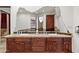 Bathroom vanity area featuring double sinks, decorative countertops, and dark wood cabinetry at 15504 E Firerock Country Club Dr, Fountain Hills, AZ 85268