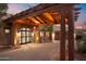 Grand covered entrance featuring stone archway, custom doors, and desert landscaping at 15504 E Firerock Country Club Dr, Fountain Hills, AZ 85268