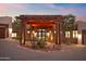 Inviting front entrance featuring a charming pergola, stone accents, and desert landscaping at 15504 E Firerock Country Club Dr, Fountain Hills, AZ 85268