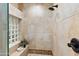 Tiled shower features neutral stone, glass block window, and oil rubbed bronze fixtures at 15504 E Firerock Country Club Dr, Fountain Hills, AZ 85268