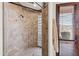 Tiled walk-in shower featuring glass block and a door to the outside with wood blinds at 15504 E Firerock Country Club Dr, Fountain Hills, AZ 85268