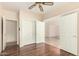 Bedroom with hardwood floors, ceiling fan, and closet at 15602 N 19Th St, Phoenix, AZ 85022