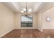 Open dining room with hardwood floors, tray ceilings, and a decorative chandelier, perfect for entertaining at 15602 N 19Th St, Phoenix, AZ 85022