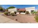 Charming single-story home with a three-car garage, desert landscaping, and a covered front porch at 15602 N 19Th St, Phoenix, AZ 85022