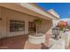 Inviting front porch featuring a tiled patio, unique planters, and a charming entrance with wood double doors at 15602 N 19Th St, Phoenix, AZ 85022