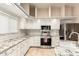 Kitchen featuring subway tile backsplash, marble counters, and stainless steel appliances at 15602 N 19Th St, Phoenix, AZ 85022