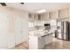 Kitchen featuring a marble island, white cabinets, stainless steel appliances, and tile floors at 15602 N 19Th St, Phoenix, AZ 85022