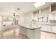 Bright kitchen featuring a marble island, white cabinets, and neutral tile floors at 15602 N 19Th St, Phoenix, AZ 85022