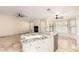 Bright kitchen featuring a marble island, neutral tile floors, and stainless steel appliances at 15602 N 19Th St, Phoenix, AZ 85022