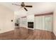 Spacious living room featuring a fireplace, hardwood floors, and access to the bathroom at 15602 N 19Th St, Phoenix, AZ 85022