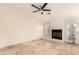 Bright living room with marble tile flooring, a cozy fireplace, a ceiling fan, and a glass door to the outside at 15602 N 19Th St, Phoenix, AZ 85022