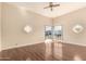 Bright living room featuring hardwood floors, modern windows, and a ceiling fan, creating a comfortable atmosphere at 15602 N 19Th St, Phoenix, AZ 85022