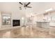 Open living room with marble floors, a fireplace, ceiling fans, and views into the kitchen and outdoor patio at 15602 N 19Th St, Phoenix, AZ 85022