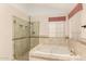 Bathroom featuring a tub, glass enclosed shower, and tile floors at 15602 N 19Th St, Phoenix, AZ 85022