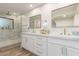 This bathroom features a shower with glass enclosure, double sinks, and white cabinets at 15747 E Greystone Dr, Fountain Hills, AZ 85268