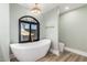 A bright bathroom features a modern soaking tub beneath a picture window and stylish fixtures at 15747 E Greystone Dr, Fountain Hills, AZ 85268