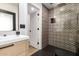 Modern bathroom featuring stylish tile, black fixtures, and a glass shower enclosure at 15747 E Greystone Dr, Fountain Hills, AZ 85268