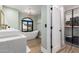 This bathroom features double sinks, a soaking tub beneath an arched window, and a walk-in closet at 15747 E Greystone Dr, Fountain Hills, AZ 85268