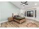 Bedroom features a ceiling fan, a window with a view, and wood-look floors at 15747 E Greystone Dr, Fountain Hills, AZ 85268