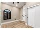 Neutral bedroom with wood-look flooring, arched window, and closet with sliding barn door at 15747 E Greystone Dr, Fountain Hills, AZ 85268