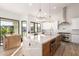 Bright kitchen with marble countertops, stainless steel appliances, white cabinets and a bar table at 15747 E Greystone Dr, Fountain Hills, AZ 85268