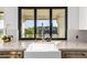 Bright kitchen sink with marble countertops, herringbone backsplash, and view of desert hillside at 15747 E Greystone Dr, Fountain Hills, AZ 85268