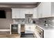 Stylish kitchenette featuring sleek white cabinetry, marble countertops, and stainless-steel appliances at 15747 E Greystone Dr, Fountain Hills, AZ 85268