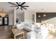 Bright living room featuring a large sectional sofa, wood floors, and modern light fixtures at 15747 E Greystone Dr, Fountain Hills, AZ 85268