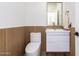 Contemporary powder room features wood paneling, white vanity, and modern fixtures at 15747 E Greystone Dr, Fountain Hills, AZ 85268