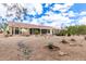 Expansive backyard with desert landscaping, stone accents, and covered patio at 16019 W Heritage Dr, Sun City West, AZ 85375