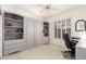 Well-organized guest bedroom featuring a murphy bed with built-in shelves, a desk and shutters at 16019 W Heritage Dr, Sun City West, AZ 85375