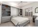Bright bedroom featuring a stylish Murphy bed with built-in shelves and storage, shutters and a modern desk at 16019 W Heritage Dr, Sun City West, AZ 85375