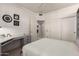 Functional bedroom offering a murphy bed with built-in shelves, neutral walls and tiled floor at 16019 W Heritage Dr, Sun City West, AZ 85375