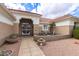 Inviting front entrance with a tiled walkway, potted plants, and a seating area at 16019 W Heritage Dr, Sun City West, AZ 85375