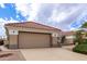 Spacious two-car garage with desert landscaping and tile roofing at 16019 W Heritage Dr, Sun City West, AZ 85375
