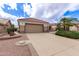 View of the two-car garage and driveway of the home with desert landscaping at 16019 W Heritage Dr, Sun City West, AZ 85375