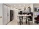 Bright kitchen with gray cabinets, stainless steel appliances, and bar stool seating at 16019 W Heritage Dr, Sun City West, AZ 85375