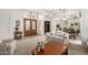 Spacious living room with a decorative front door, open layout, and comfortable floral sofa set at 16019 W Heritage Dr, Sun City West, AZ 85375