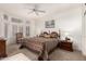 Spacious primary bedroom featuring a large window, ceiling fan and an art piece on the wall at 16019 W Heritage Dr, Sun City West, AZ 85375
